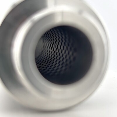Close-up of a metallic cylindrical object with a mesh or perforated interior, viewed from one end against a white background.