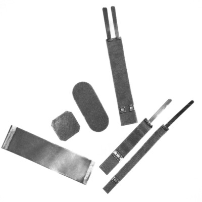 Assorted metal objects and strips of varying shapes and sizes arranged on a white background.