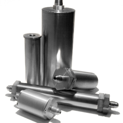 Four stainless steel industrial filter housings with threaded connectors are arranged on a white background.